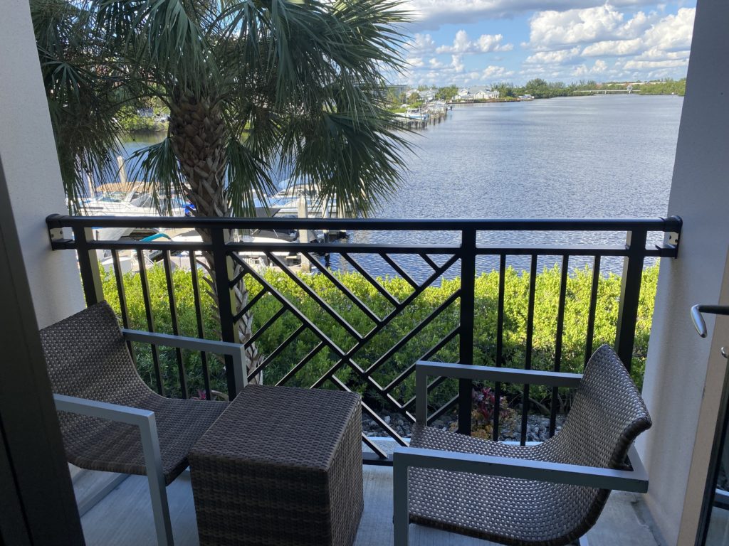 a deck with chairs and a body of water