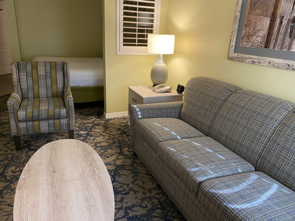 a couch and chair in a hotel room