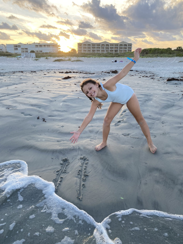 a girl in a bathing suit on a beach