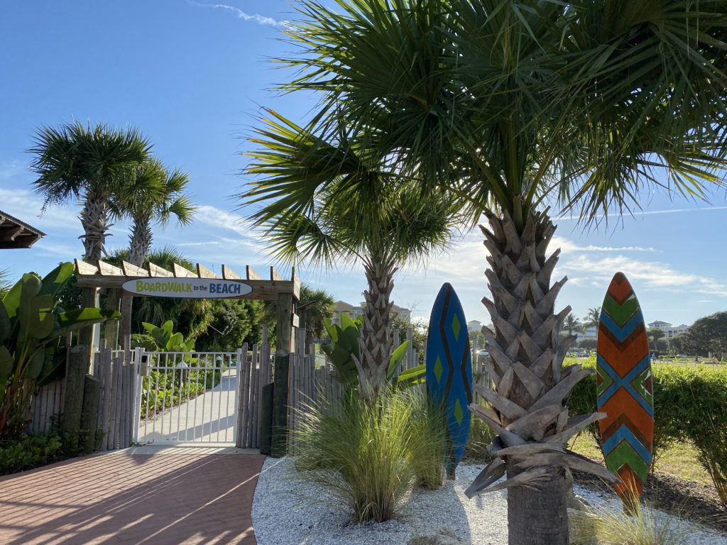 palm trees next to a gate