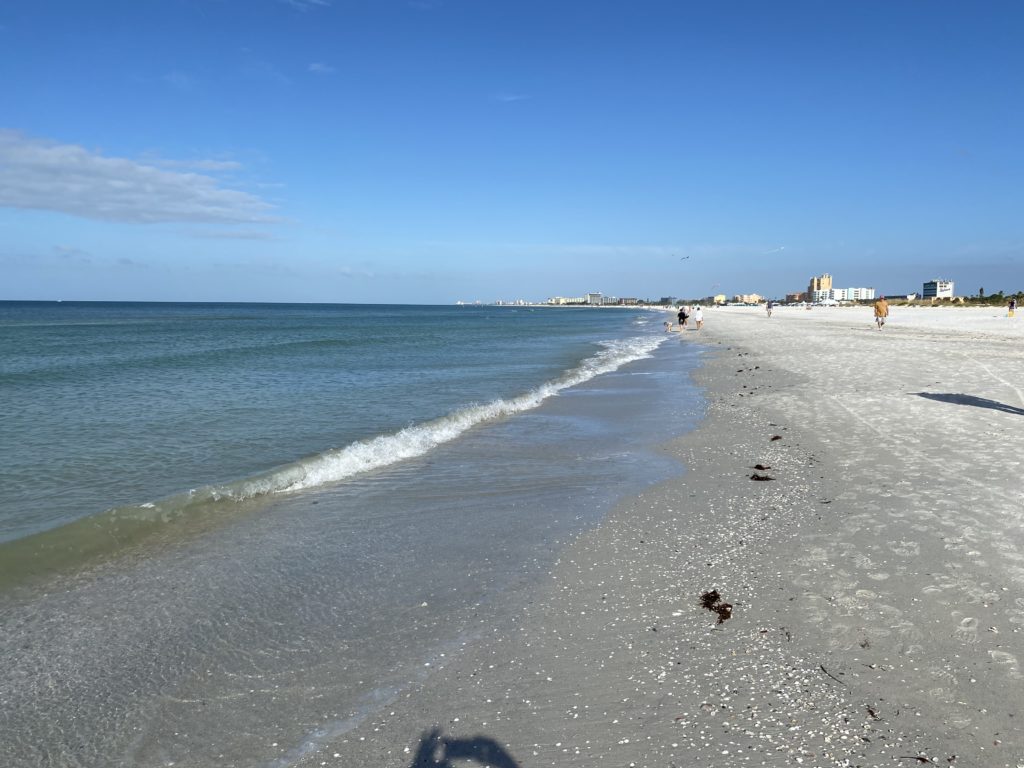 a beach with waves and buildings
