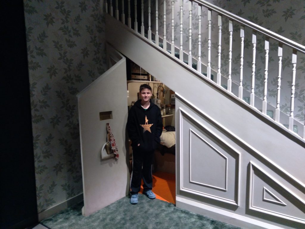 a boy standing in a hallway