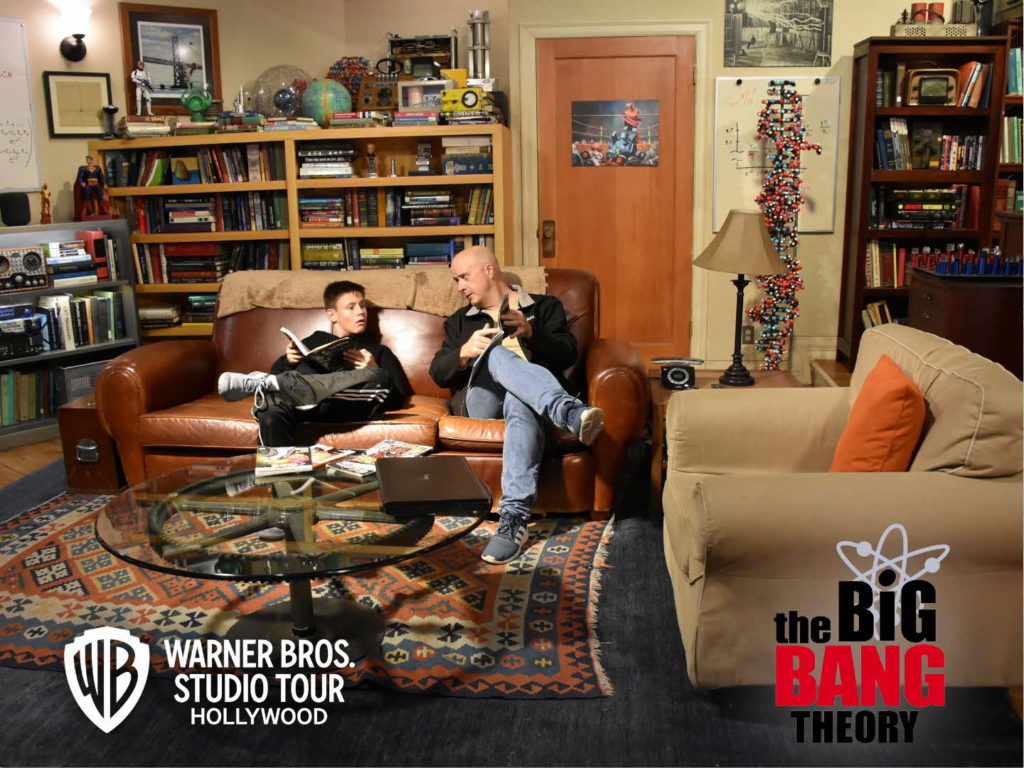 a man and boy sitting on a couch in a living room