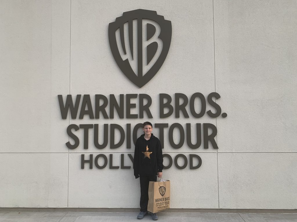 a man standing in front of a sign