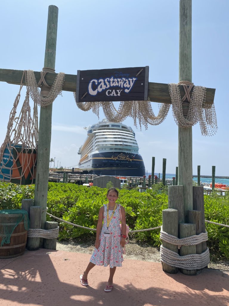 a girl standing in front of a large ship