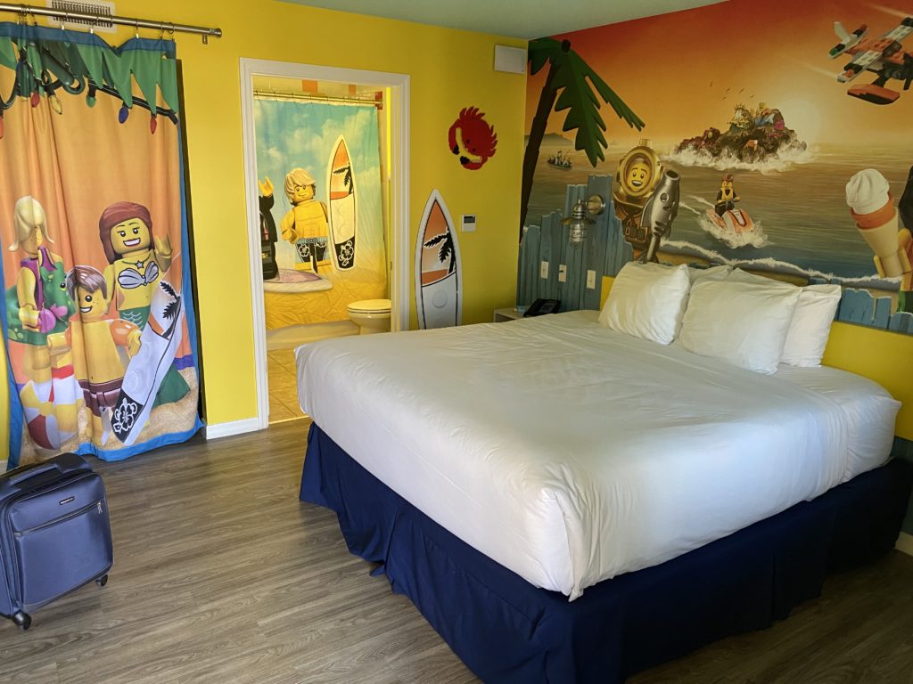 a bedroom with a bed and a mural