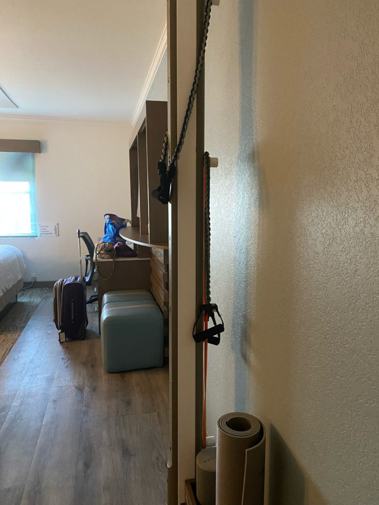 a room with a bed and luggage