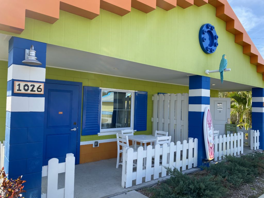 a building with a white fence and a blue door