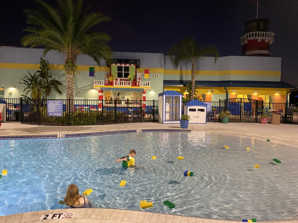 a group of kids in a pool with building blocks