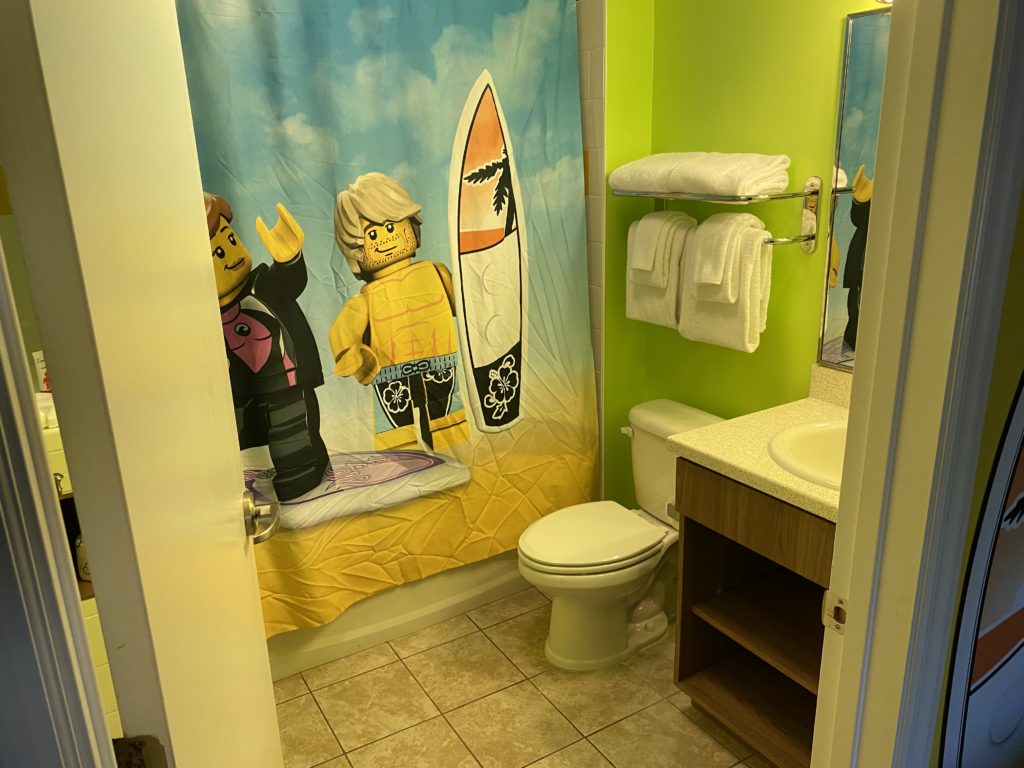 a bathroom with a shower curtain and a toilet