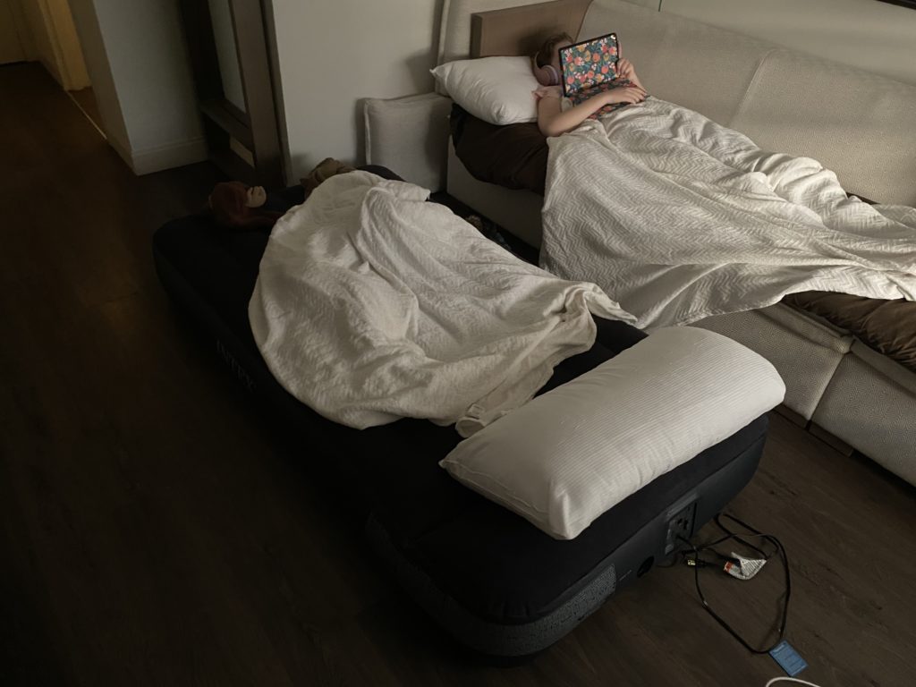 a person lying in bed with a laptop