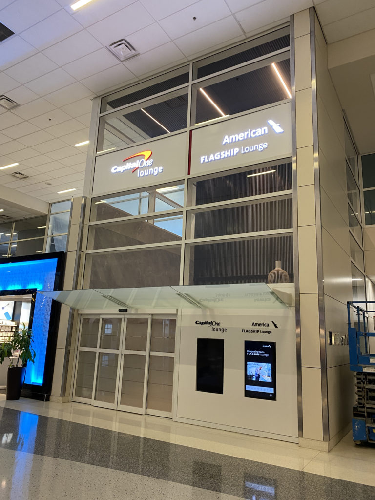 a building with glass windows and signs
