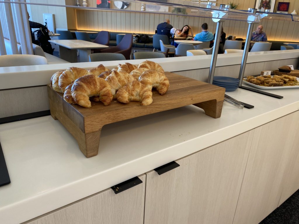 a group of croissants on a wooden board