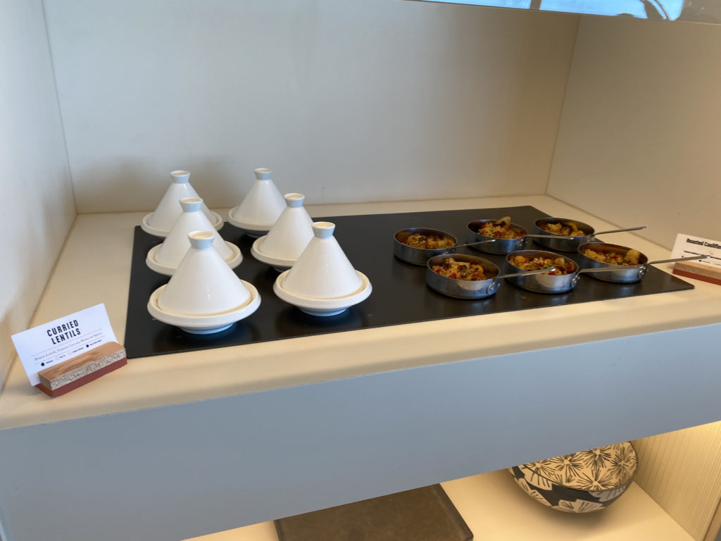 a group of small bowls of food on a black surface