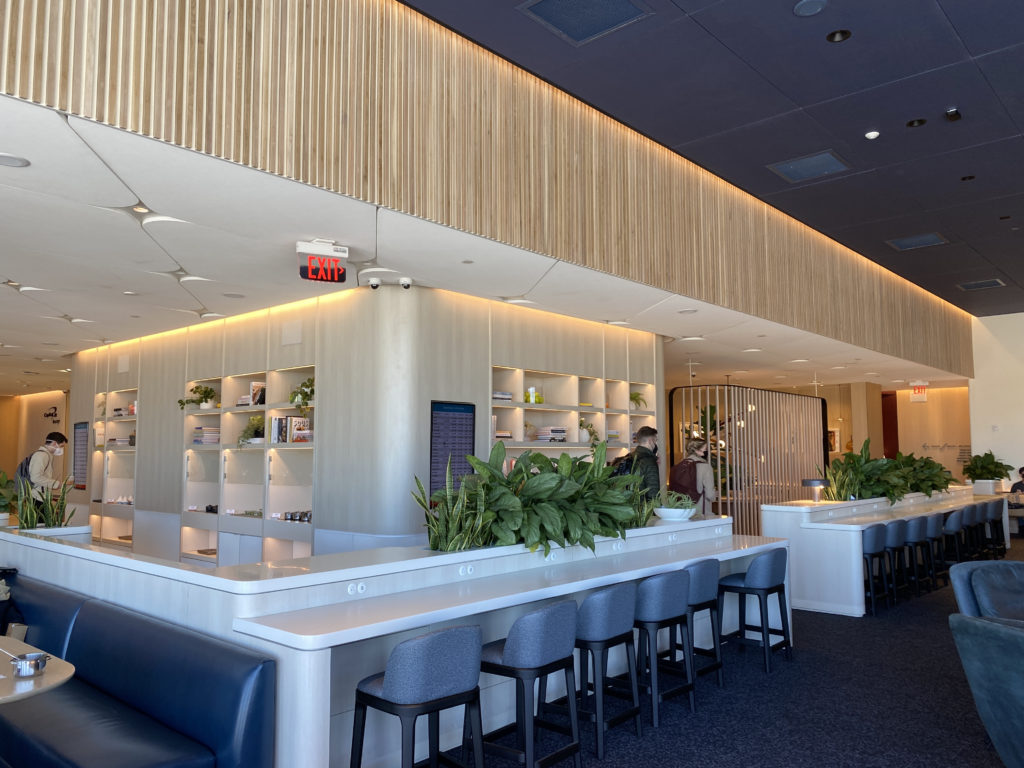 a room with a long counter and chairs