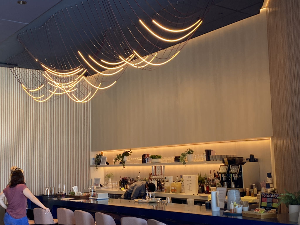 a bar with lights from the ceiling