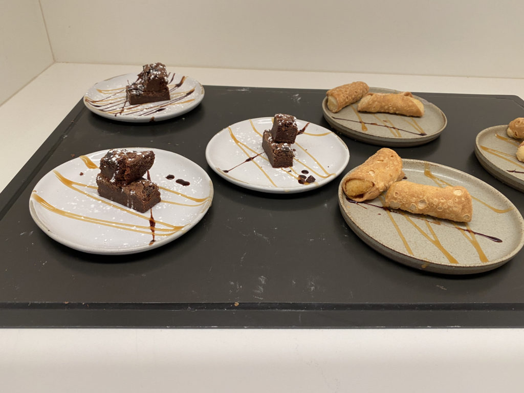 a plate of desserts on a black surface