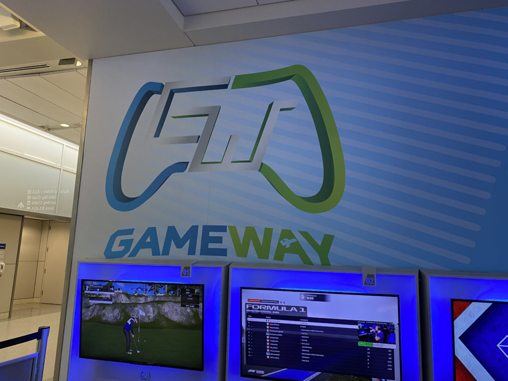 a wall with a sign and a video game controller