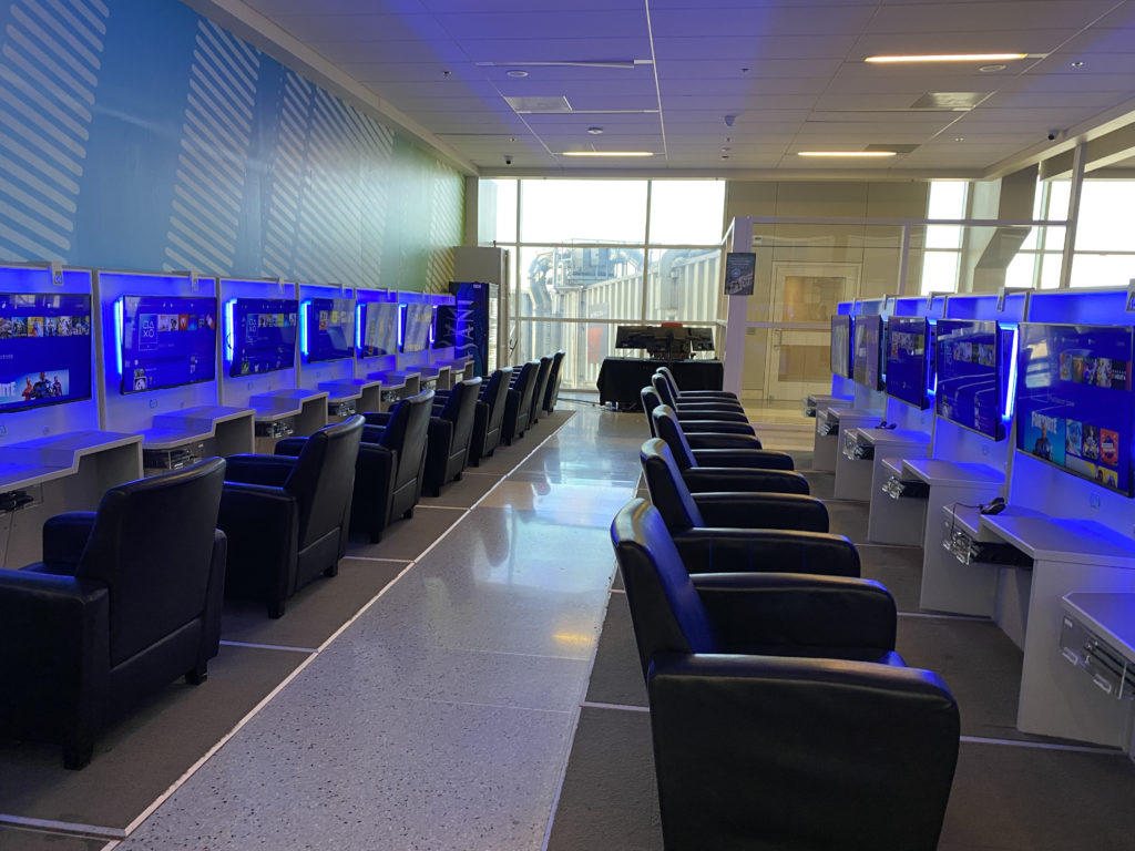 a room with a row of computer monitors