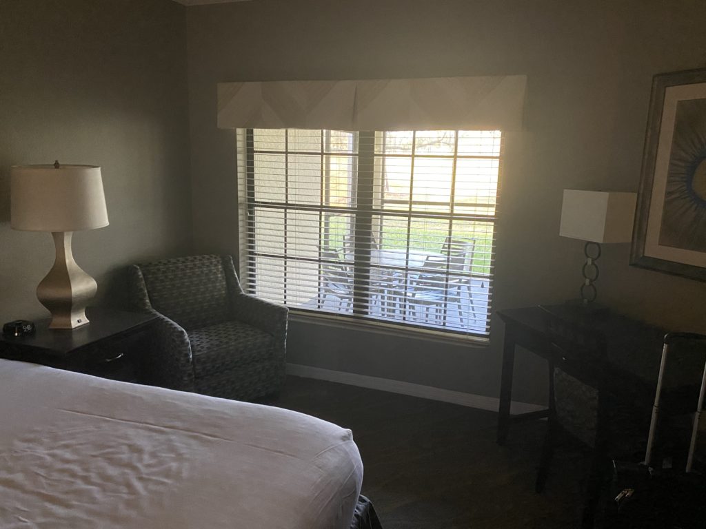 a bedroom with a bed and a chair