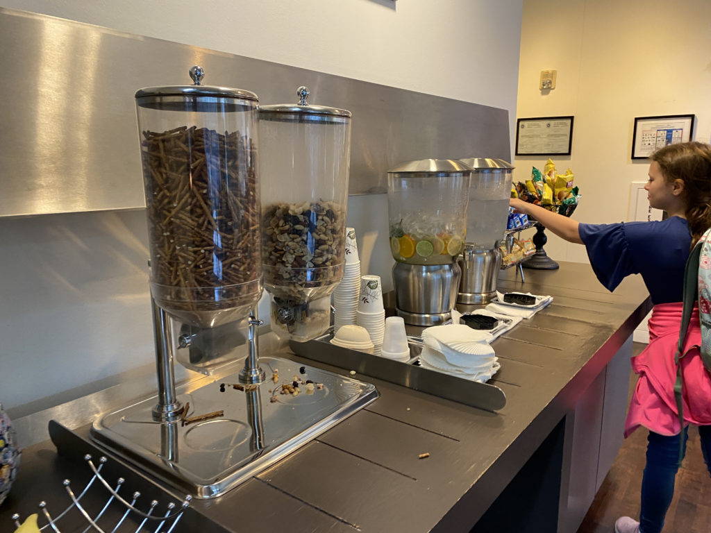 a person standing behind a counter with a couple of containers of food