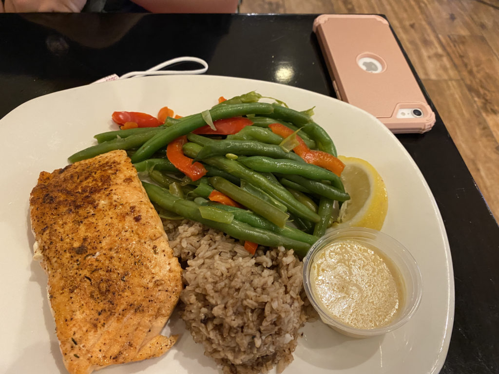 a plate of food with a phone and a phone on the table