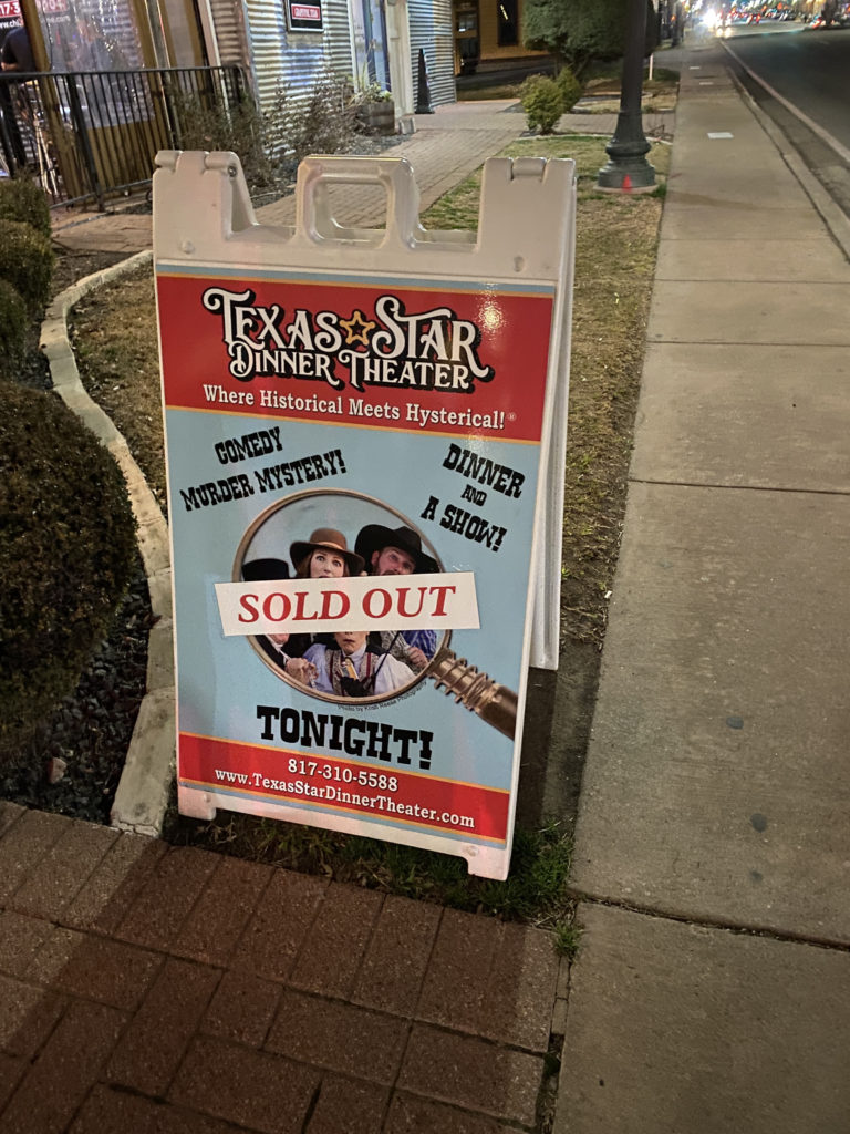 a sign on the sidewalk