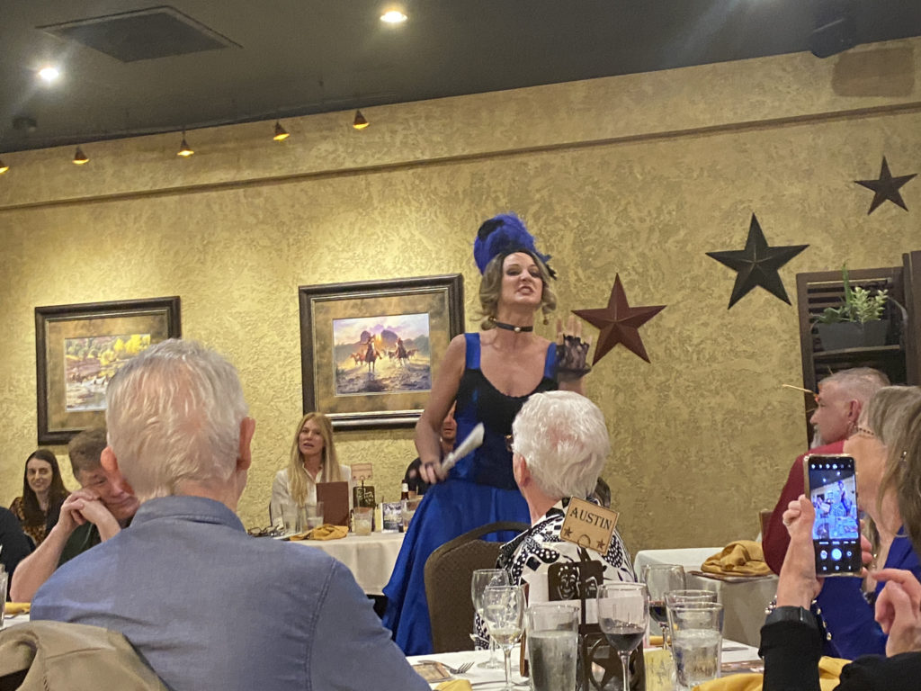 a woman in a blue dress and a blue hat