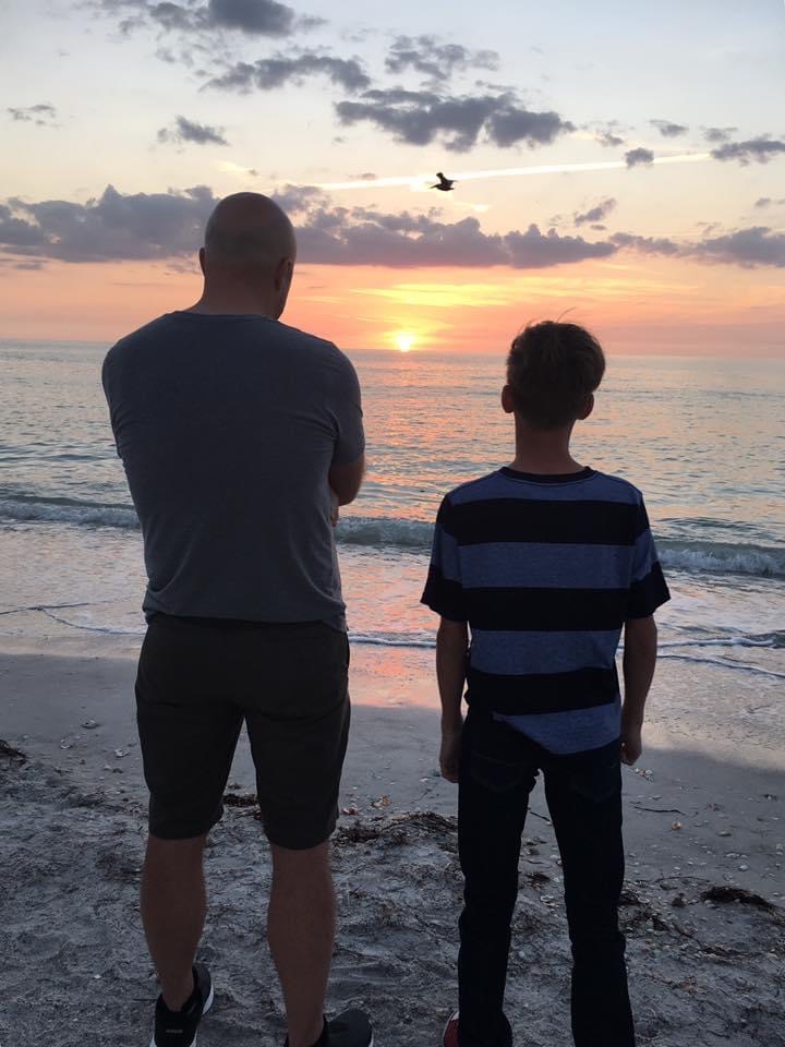 two men looking at the sunset
