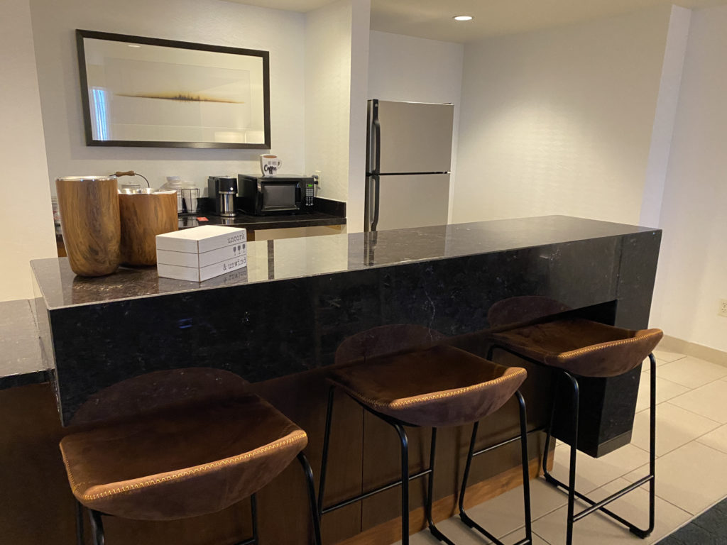 a kitchen with a bar and stools