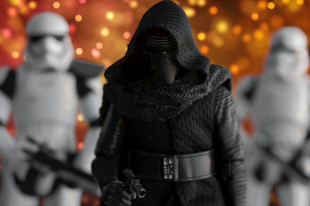 a toy figure in black with a black mask and a black hood