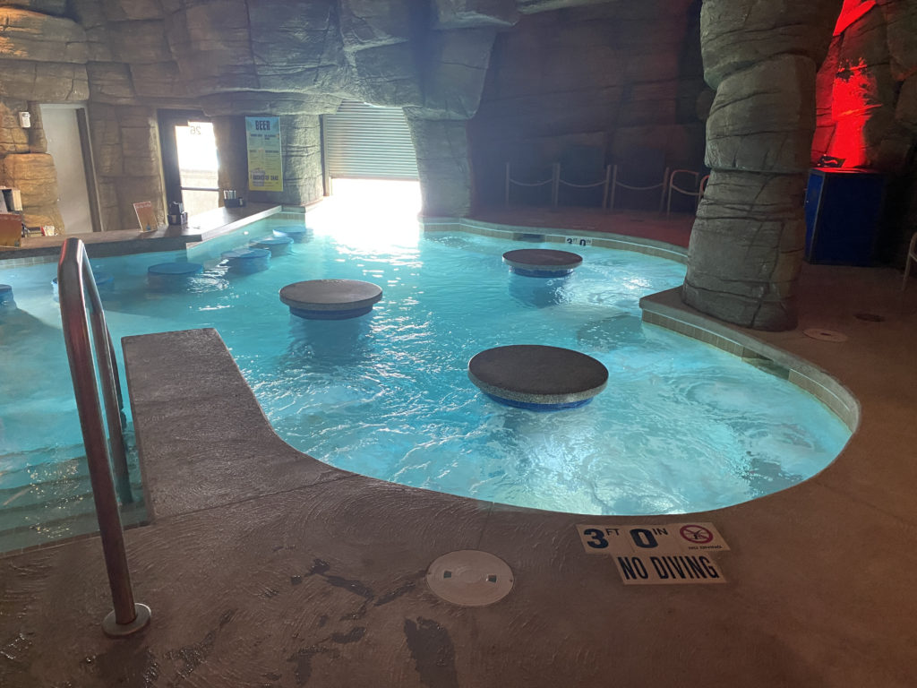 a pool with stools in a cave