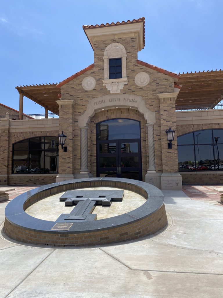 a building with a large circular fountain in front of it