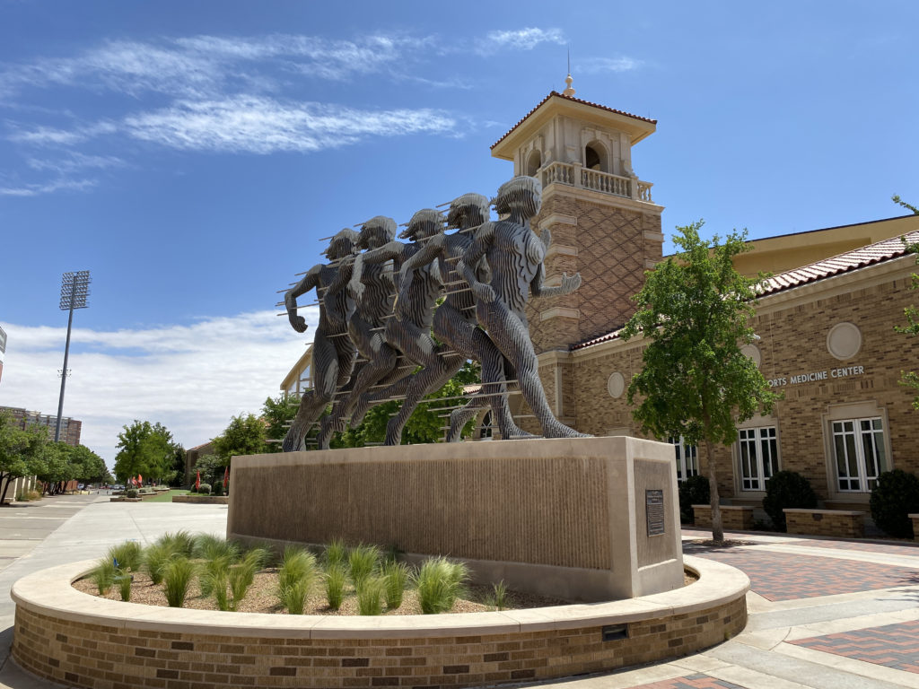 a statue of a group of running men