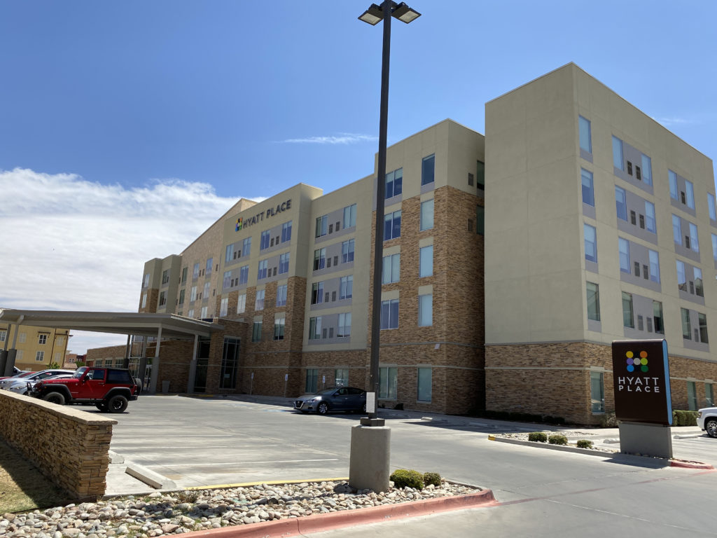 a building with a parking lot and a parking lot