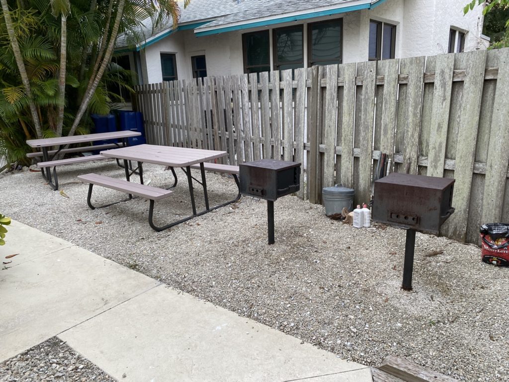 a picnic table and benches in a yard