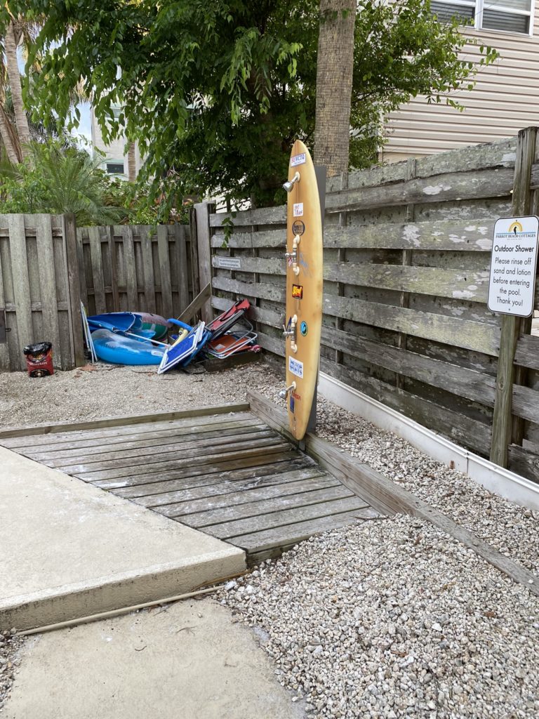 a surfboard leaning against a fence