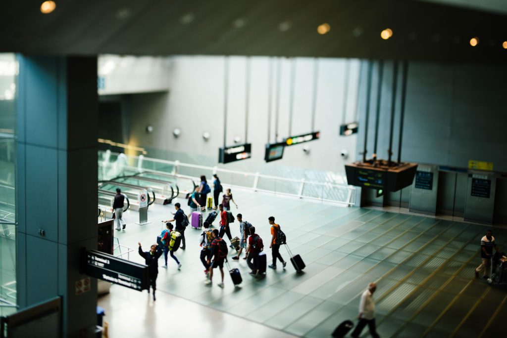 a group of people with luggage in a airport