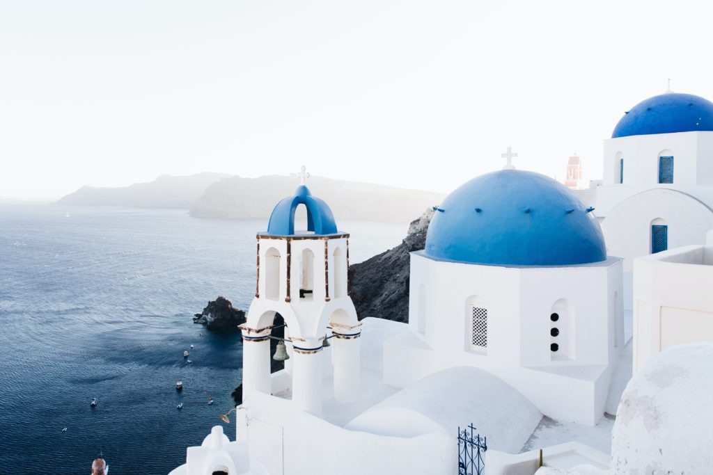 a white building with blue dome and a blue roof