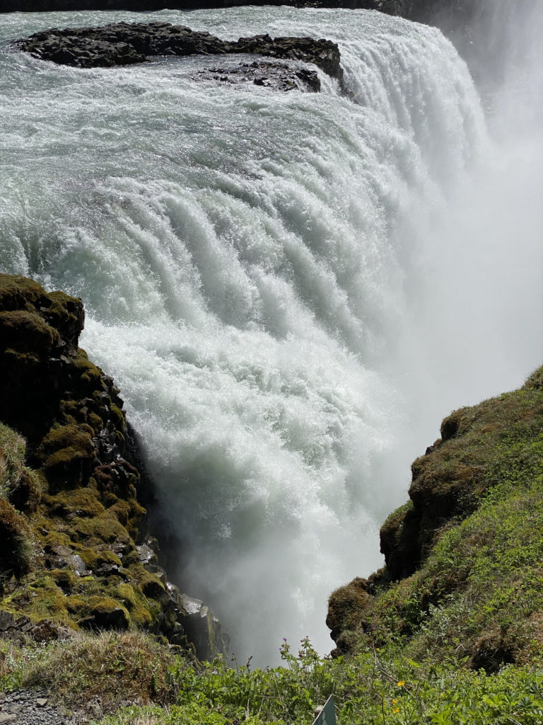 a waterfall with a cliff edge