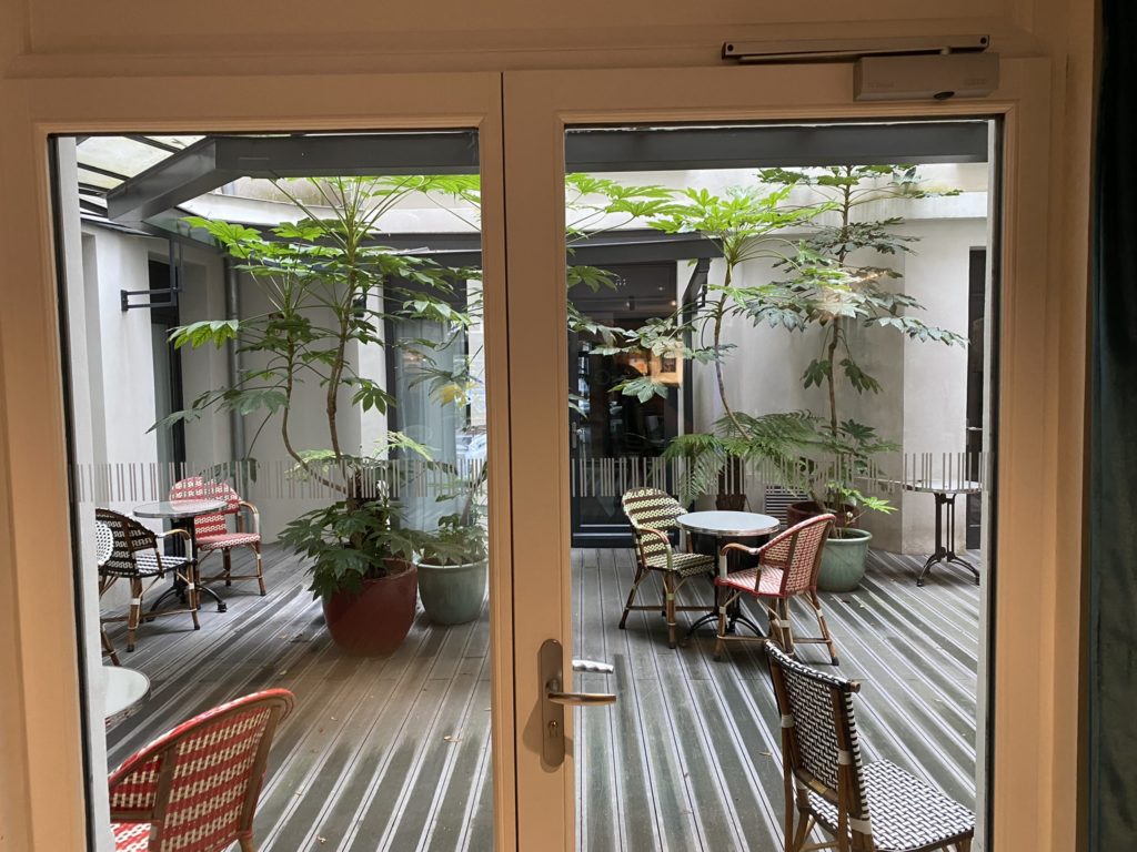 a patio with chairs and tables