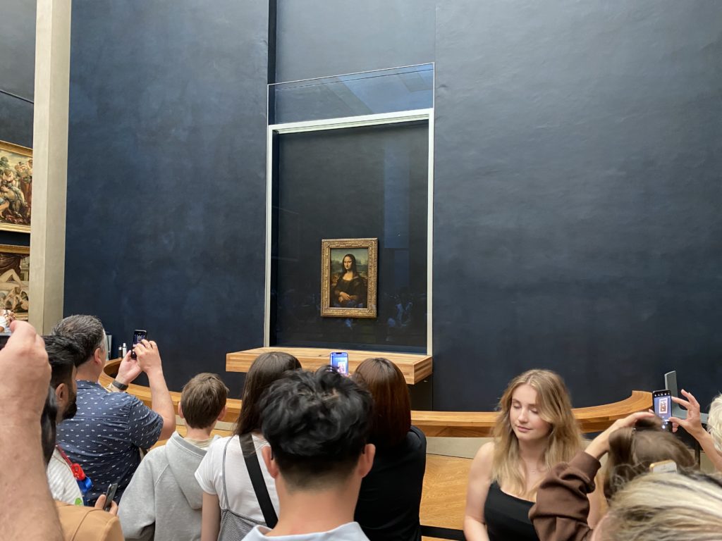 a group of people looking at a painting