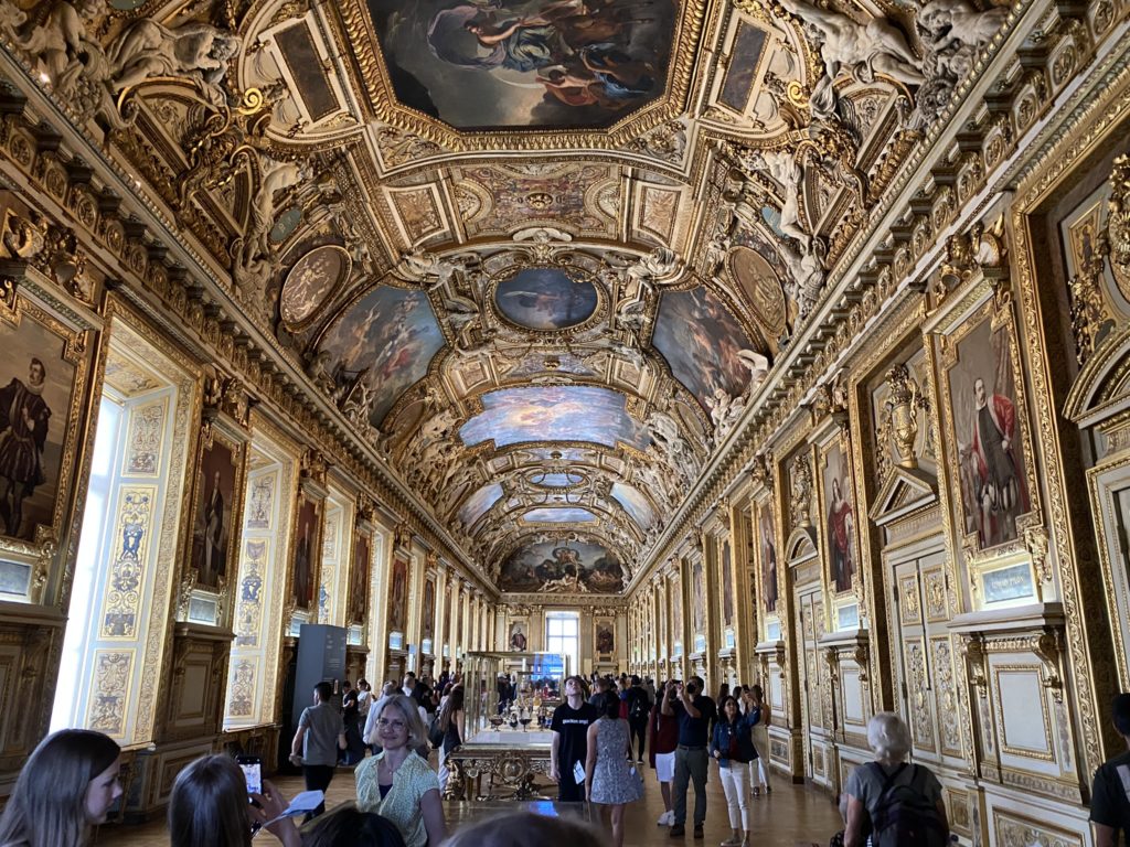 a large ornate room with many paintings on the ceiling