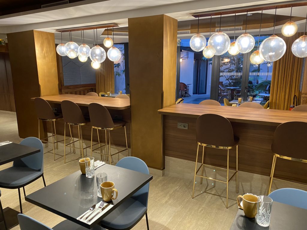 a room with tables and chairs and a bar