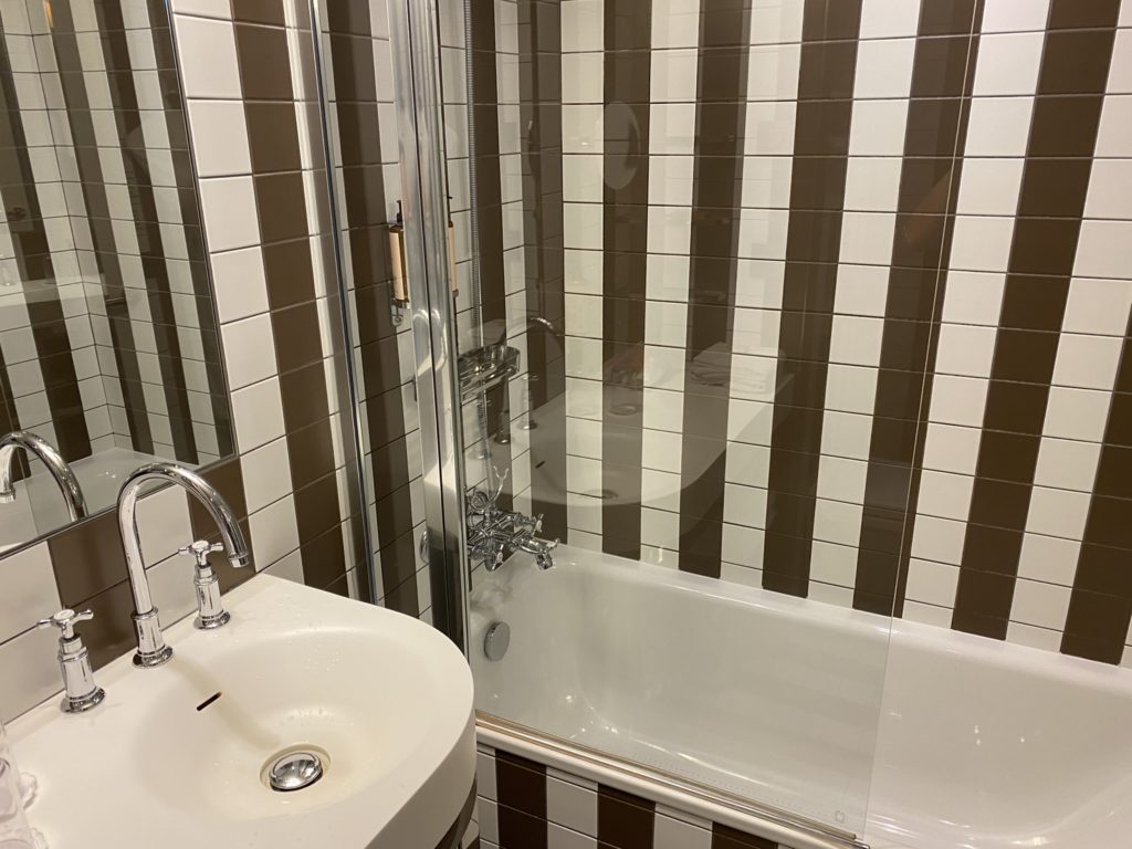 a bathroom with a shower and sink