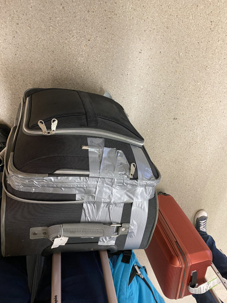 a suitcase with tape on it