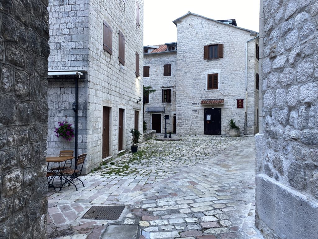 a stone buildings with chairs and tables
