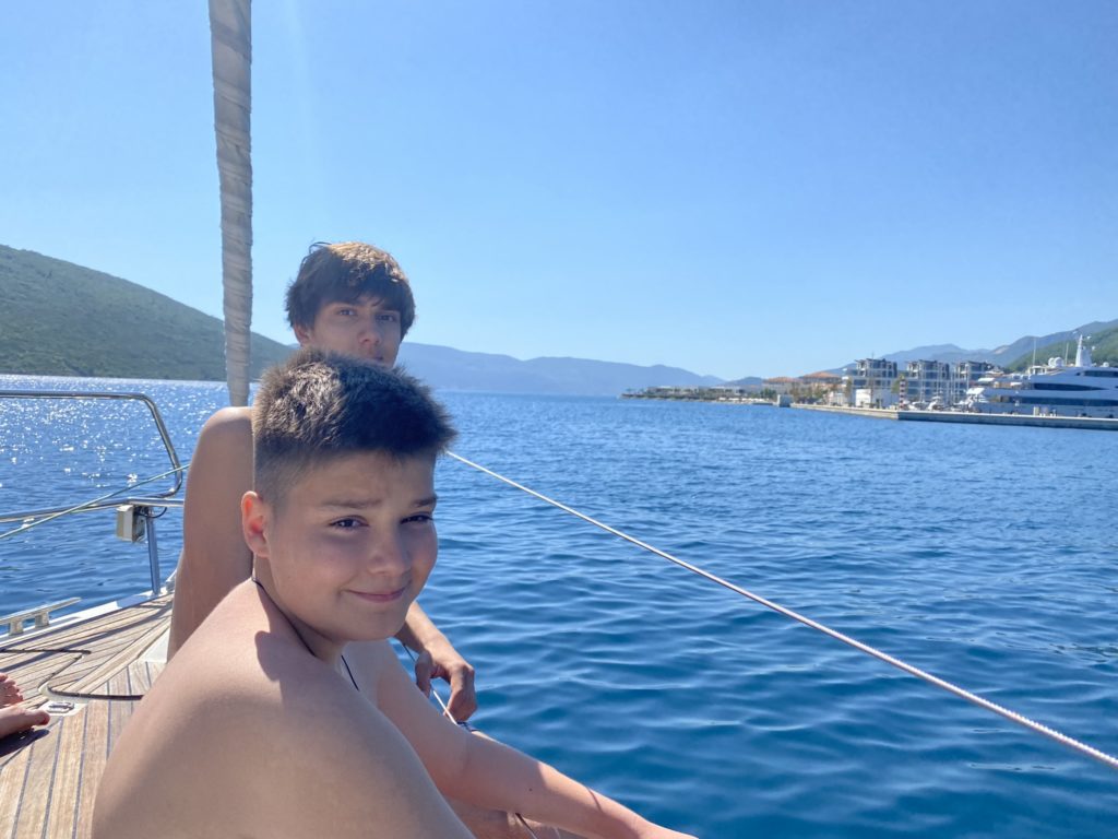 two boys sitting on a boat