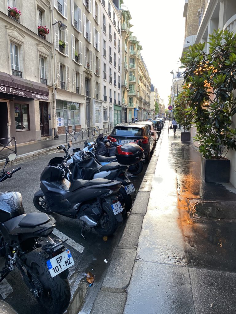 a row of motorcycles parked on a street