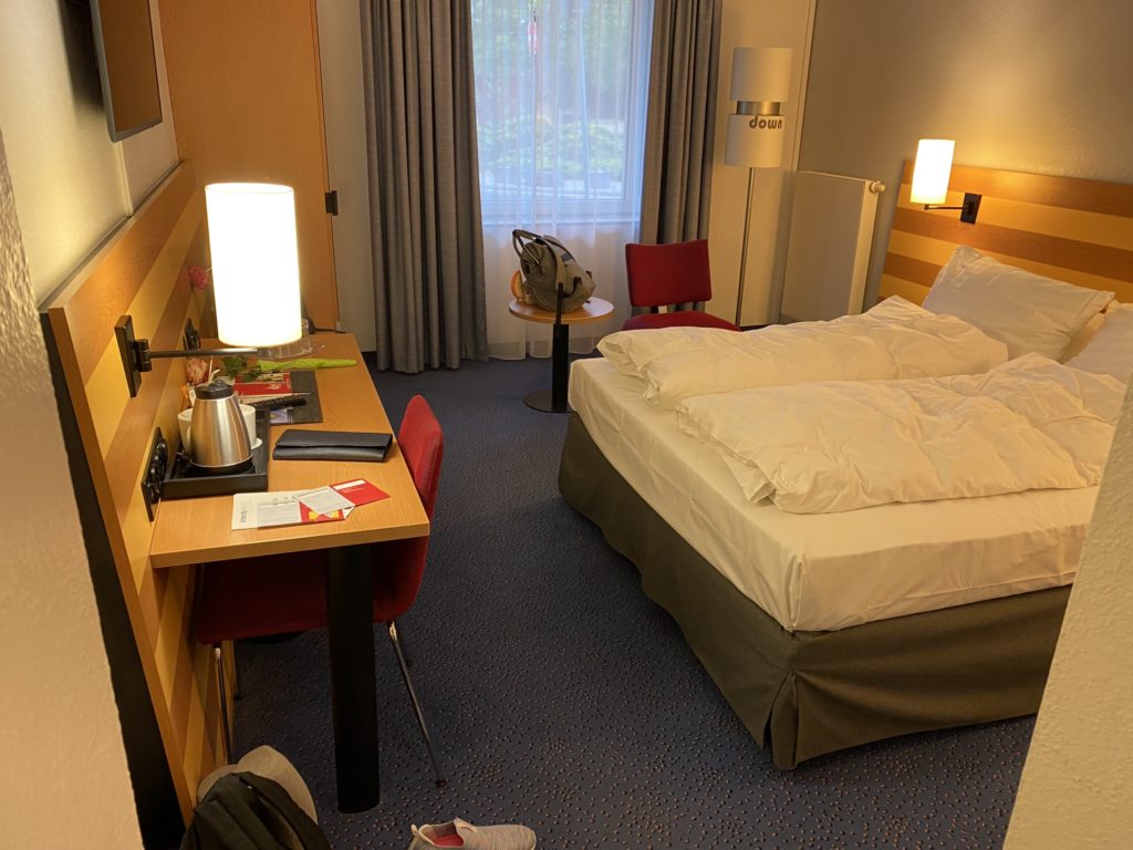 a hotel room with a bed and a desk
